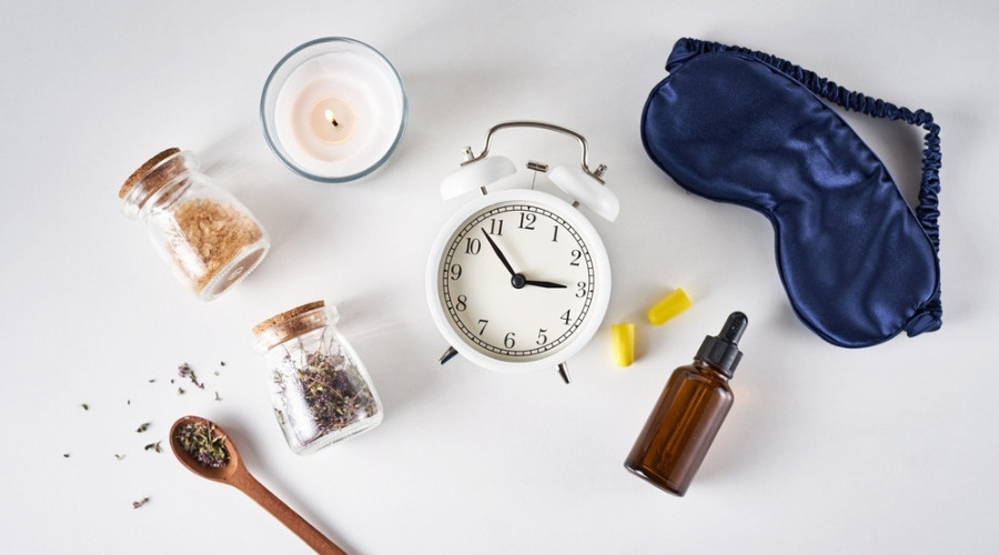best essential oil for sleep - different sleep items and oils on a table