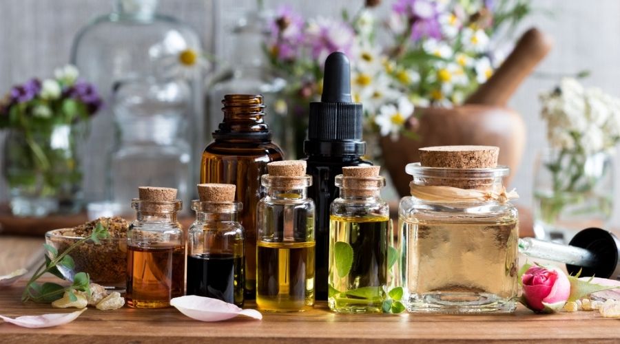 fragrance oil vs essential oil - bottles of oils on table