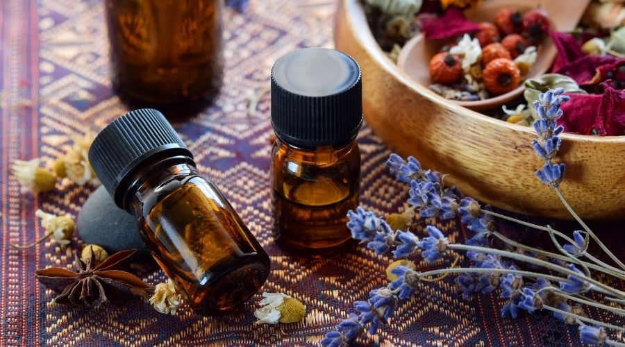 lavender essential oil and other natural products on table
