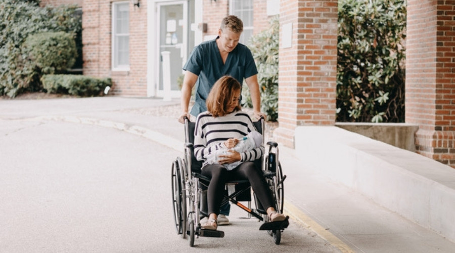 woman in wheelchair with her baby using essential oil inhaler